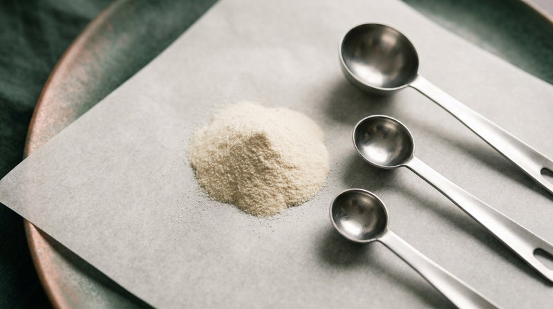 Editorial still life of hydrolysed collagen powder with measuring scoops of different sizes on parchment