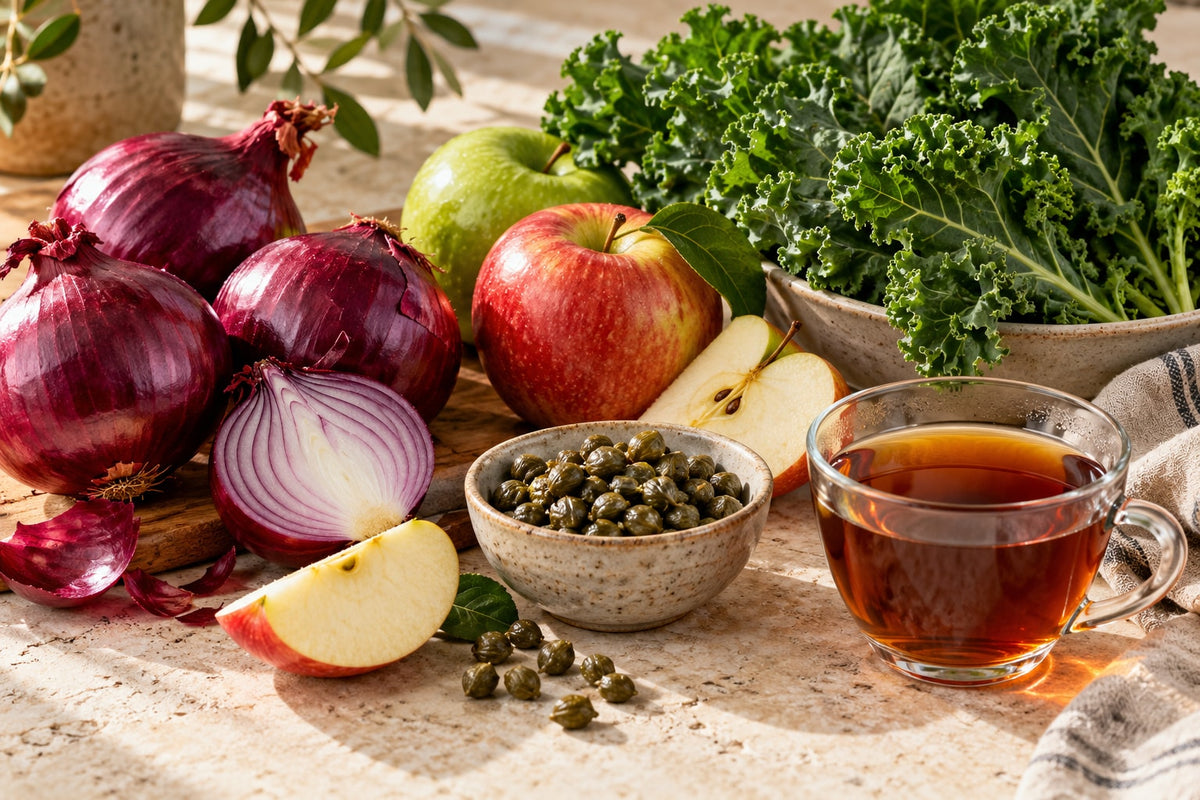 Onions, apples, leafy greens, capers and tea illustrating varied food sources