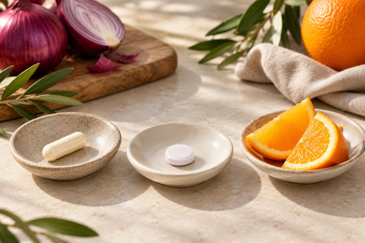 Unbranded capsule and tablet with orange wedges illustrating separate supplement ingredients